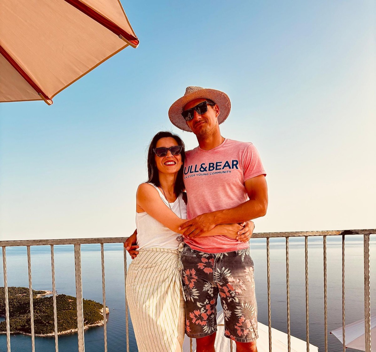 The couple behind Dubrovnik Sky View on the terrace, the sea and Lokrum behind them.